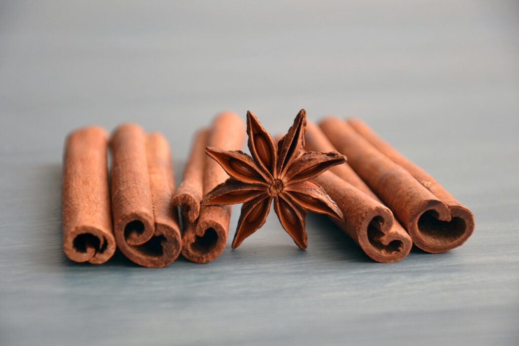 pexels-photo-1008747-1008747 Cinnamon sticks and star anise on a wooden surface, perfect for culinary themes.