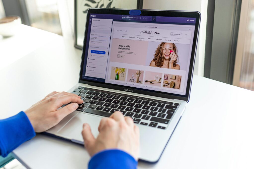 pexels-photo-17485350-17485350 Hands typing on a laptop with an e-commerce website open, showcasing online shopping.
